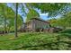 Charming exterior of home, featuring a well-manicured lawn, stone accents, and scenic lake views at 4786 Heather Ln, Denver, NC 28037