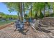 Brick firepit with Adirondack chairs for relaxing in the wooded backyard by the water at 4786 Heather Ln, Denver, NC 28037