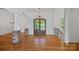 Elegant foyer featuring hardwood floors, stone pillars, and custom lighting at 4786 Heather Ln, Denver, NC 28037