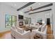 Bright living room with modern seating, a fireplace, TV, and a water view at 4786 Heather Ln, Denver, NC 28037