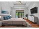 Main bedroom with lake view, tray ceiling, and access to an outdoor balcony at 4786 Heather Ln, Denver, NC 28037