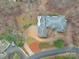 Aerial view of a home with a gray roof, circular driveway, and surrounded by trees and landscaping at 503 Stuart Rdg, Cramerton, NC 28032