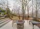 Back deck with outdoor seating area, including a fire pit and chairs with a nature view at 503 Stuart Rdg, Cramerton, NC 28032