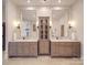 Bathroom with dual sinks, wooden vanity, marble countertops, and large mirrors at 503 Stuart Rdg, Cramerton, NC 28032