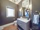 Stylish bathroom with modern vanity, elegant mirror, and ample lighting at 503 Stuart Rdg, Cramerton, NC 28032