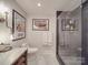 Modern bathroom featuring glass shower, marble countertop, decorative lighting, and artwork at 503 Stuart Rdg, Cramerton, NC 28032