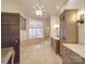 Luxurious bathroom with soaking tub, elegant lighting, tile floors, and wooden cabinets at 503 Stuart Rdg, Cramerton, NC 28032