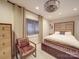Cozy bedroom featuring a bed with a wood headboard, an armchair, a window, and modern lighting at 503 Stuart Rdg, Cramerton, NC 28032