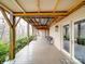 Covered porch with exposed beams and posts, multiple seating areas, and french doors at 503 Stuart Rdg, Cramerton, NC 28032
