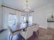 Bright dining room featuring a chandelier, table with six chairs, and large windows with natural light at 503 Stuart Rdg, Cramerton, NC 28032