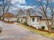 Stately home featuring a stone chimney and accents, complimented by a circular driveway and mature trees at 503 Stuart Rdg, Cramerton, NC 28032