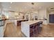 Spacious kitchen features white cabinets, hardwood floors, marble countertops, and dual islands at 503 Stuart Rdg, Cramerton, NC 28032