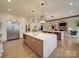 Spacious kitchen with double island, hardwood floors, modern lighting and stainless steel appliances at 503 Stuart Rdg, Cramerton, NC 28032