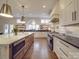 Bright modern kitchen with a large island, stainless steel appliances, custom cabinets and hardwood floors at 503 Stuart Rdg, Cramerton, NC 28032