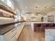Bright modern kitchen with a large island, stainless steel appliances, custom cabinets and hardwood floors at 503 Stuart Rdg, Cramerton, NC 28032