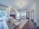 Elegant living room with a fireplace, chandelier, hardwood floors and plenty of natural light at 503 Stuart Rdg, Cramerton, NC 28032