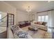 Bright and airy living room with a chandelier, large windows and hardwood floors at 503 Stuart Rdg, Cramerton, NC 28032
