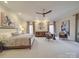 Bright primary bedroom with ceiling fan, hardwood floors, art and window views at 503 Stuart Rdg, Cramerton, NC 28032