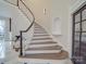 Elegant curved staircase with hardwood steps, white risers and iron railing at 503 Stuart Rdg, Cramerton, NC 28032