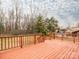 Exterior back deck overlooking a backyard with multiple trees and a house behind a chain link fence at 608 E Matthews St, Matthews, NC 28105