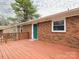 Exterior back deck featuring a red brick home with a green back door, and a big green tree at 608 E Matthews St, Matthews, NC 28105