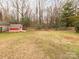 Spacious backyard featuring a storage shed and mature trees, perfect for outdoor activities at 608 E Matthews St, Matthews, NC 28105