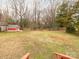 Large backyard with a shed and mature trees providing privacy and shade at 608 E Matthews St, Matthews, NC 28105