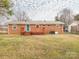 Brick house with a wooden deck and a spacious yard at 608 E Matthews St, Matthews, NC 28105