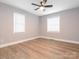 Bedroom features fresh paint, updated flooring, two windows, and a ceiling fan at 608 E Matthews St, Matthews, NC 28105