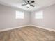 Bedroom features two windows, fresh paint, modern flooring, and a ceiling fan at 608 E Matthews St, Matthews, NC 28105