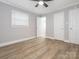 Light and airy bedroom with modern flooring, ceiling fan and fresh neutral paint at 608 E Matthews St, Matthews, NC 28105