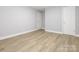 Bedroom with wood-look flooring, fresh paint, baseboards and two doors at 608 E Matthews St, Matthews, NC 28105