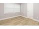Bedroom with light gray walls, wood floor, and a double window for plenty of natural light at 608 E Matthews St, Matthews, NC 28105