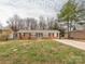 Charming brick home featuring a well-manicured lawn and inviting curb appeal at 608 E Matthews St, Matthews, NC 28105
