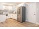 Kitchen with new stainless appliances, white cabinets, marble backsplash, and open doorway at 608 E Matthews St, Matthews, NC 28105