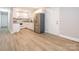 Bright kitchen features white cabinetry, stainless steel appliances, and granite countertops at 608 E Matthews St, Matthews, NC 28105