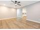 Spacious living room featuring new flooring, ceiling fan, and an open layout at 608 E Matthews St, Matthews, NC 28105