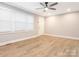 Bright living room with new flooring, crown molding, a ceiling fan, and a large window at 608 E Matthews St, Matthews, NC 28105