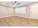 Bright living room with new flooring, crown molding, a ceiling fan, and a large window at 608 E Matthews St, Matthews, NC 28105