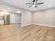 Spacious living room featuring new flooring, ceiling fan, and an open layout at 608 E Matthews St, Matthews, NC 28105