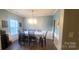 Elegant dining room features modern chandelier and wainscoting for a touch of sophistication at 6237 Shelley Ave, Charlotte, NC 28269