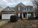 Charming two-story home with a two car garage, brick and vinyl siding and blue shutters at 6237 Shelley Ave, Charlotte, NC 28269