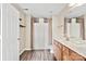 Bright bathroom featuring double sinks, wood cabinets, and updated lighting at 9724 Walkers Glen Nw Dr, Concord, NC 28027