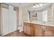 Well-lit bathroom featuring double vanity, wood cabinets, and shower with curtain at 9724 Walkers Glen Nw Dr, Concord, NC 28027