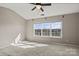 Bright bedroom with large windows and neutral carpeting, perfect for relaxation at 9724 Walkers Glen Nw Dr, Concord, NC 28027