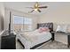 Cozy bedroom with large windows, ceiling fan, and modern furnishings at 9724 Walkers Glen Nw Dr, Concord, NC 28027