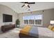 Comfortable bedroom with natural light, ceiling fan, and large window overlooking the neighborhood at 9724 Walkers Glen Nw Dr, Concord, NC 28027