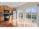 Bright kitchen with stainless steel appliances, island, and sliding doors to patio at 9724 Walkers Glen Nw Dr, Concord, NC 28027