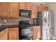 Classic kitchen featuring wood cabinets, stainless steel appliances, and neutral backsplash at 9724 Walkers Glen Nw Dr, Concord, NC 28027