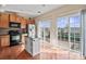 Bright kitchen with stainless steel appliances, island, and sliding doors to patio at 9724 Walkers Glen Nw Dr, Concord, NC 28027